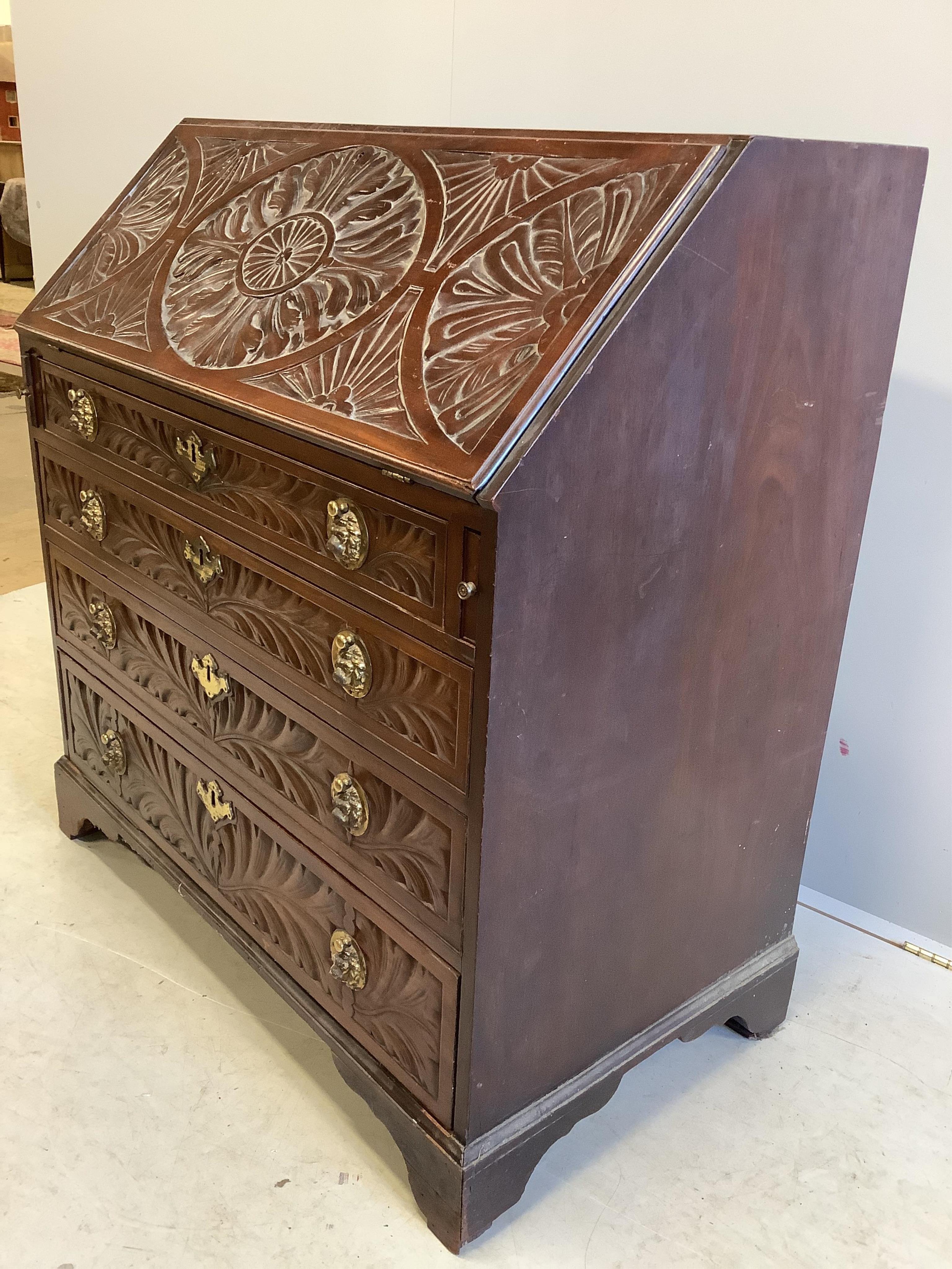 A George III later carved mahogany bureau, width 99cm, depth 56cm, height 106cm. Condition - fair